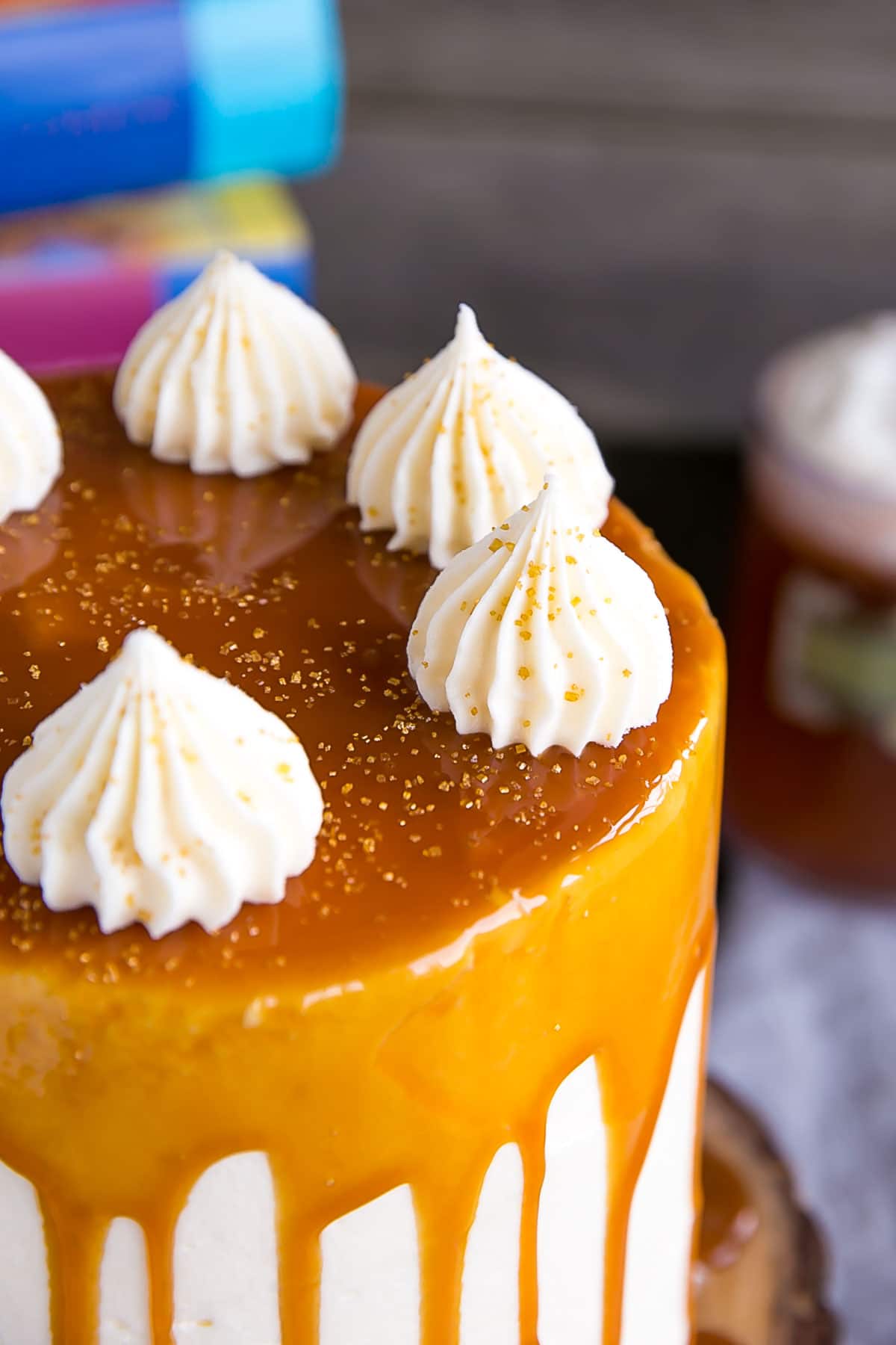 Harry Potter Cake! This Butterbeer cake combines butterscotch, cream soda, and marshmallow all in one spellbinding dessert. | livforcake.com Close up of dollops on this Butterbeer Cake.