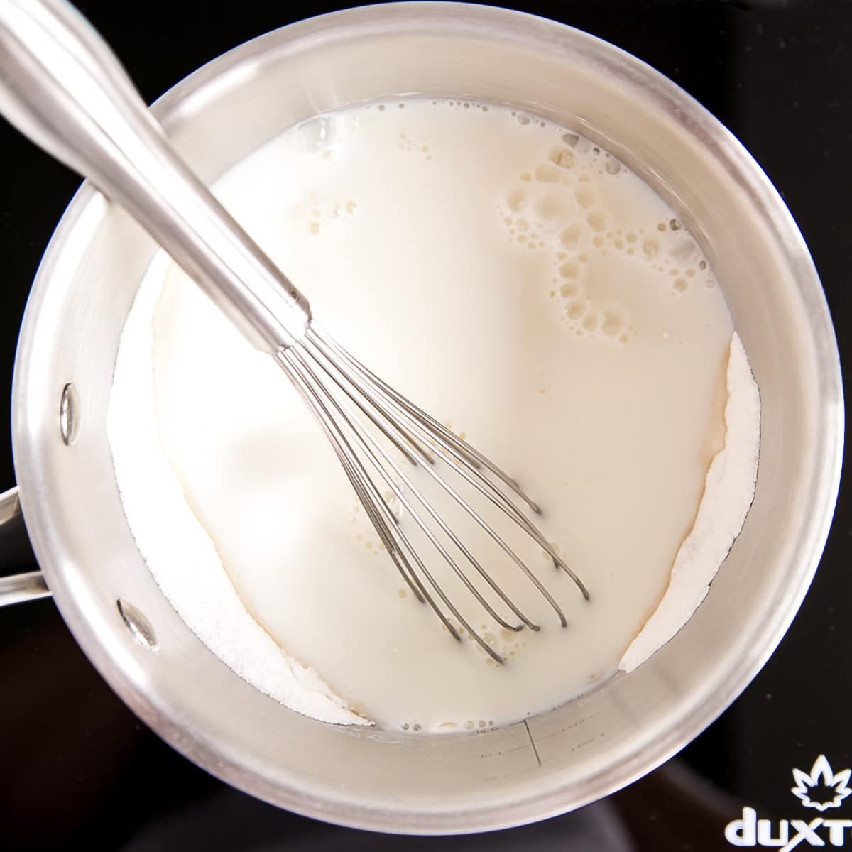 Ermine Frosting (also known as flour buttercream or heritage frosting) is an easy and delicious buttercream made with flour, sugar, milk, and butter. | livforcake.com Milk added to the pot with the flour, sugar, and salt.
