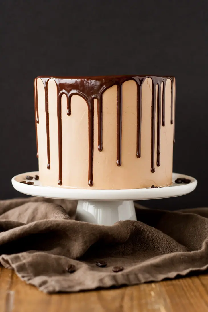 Mocha Cake! A rich dark chocolate cake with a silky mocha swiss meringue buttercream. | livforcake.com Close up of a cake.
