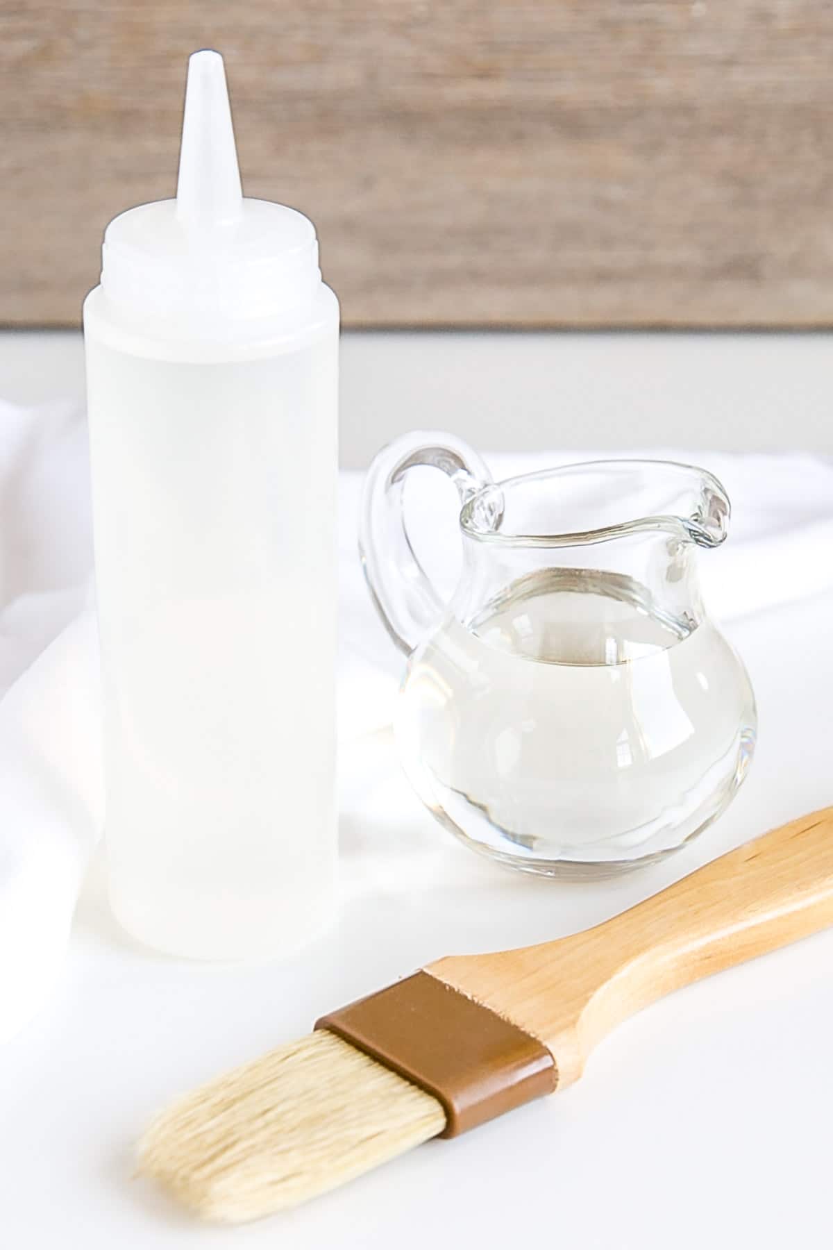 Make simple syrup at home with this quick and easy recipe! The perfect addition to your cakes, cocktails, and iced beverages. | livforcake.com Tools used to use the syrup on cakes.